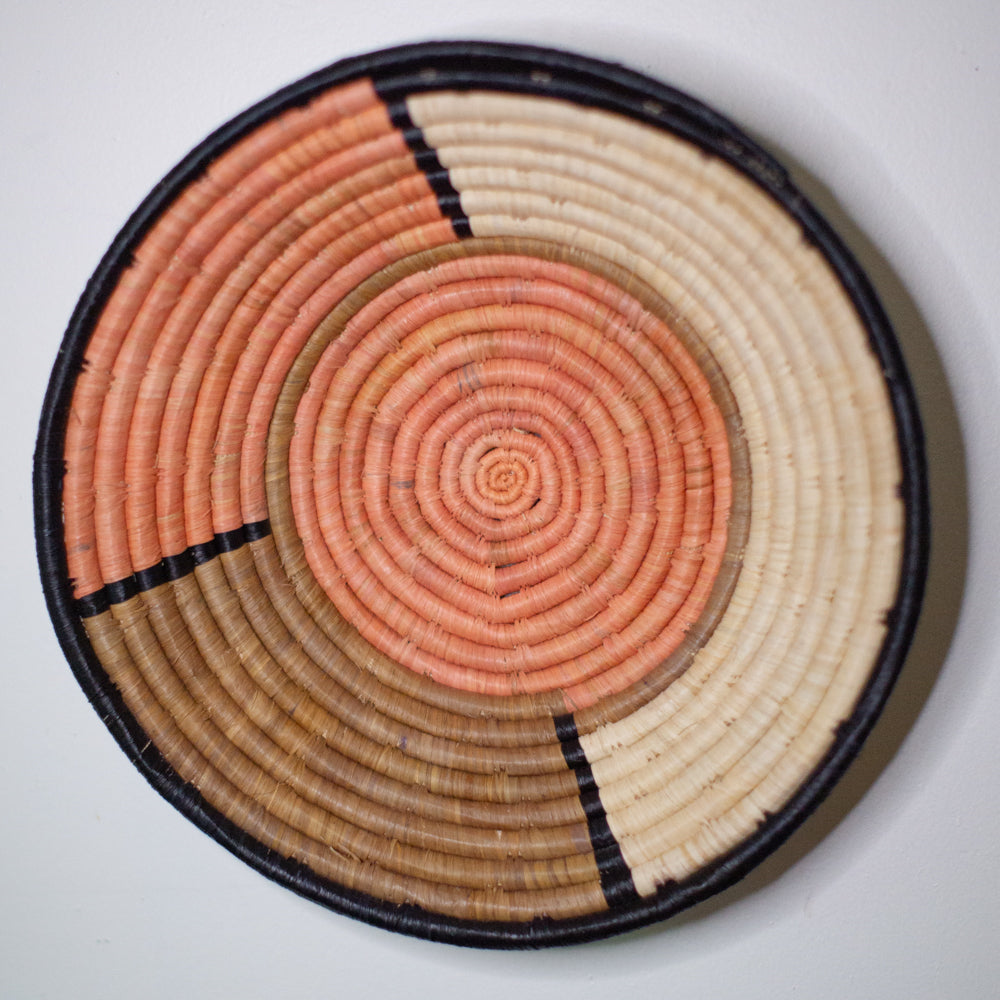 JustOne's tan and pink basket handwoven in Uganda