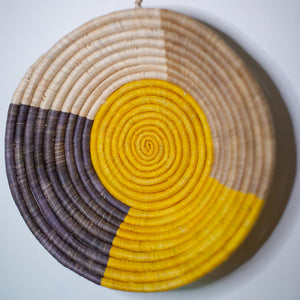 JustOne's wall basket with yellow grey and tan in quarter sections, handwoven in Uganda