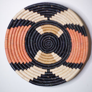 JustOne's pink, black, and tan hanging basket handwoven in Uganda