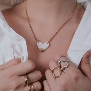 JustOne's brass chain necklace with small white and brass heart charm, handcrafted from ethically sourced bone and brass in Kenya