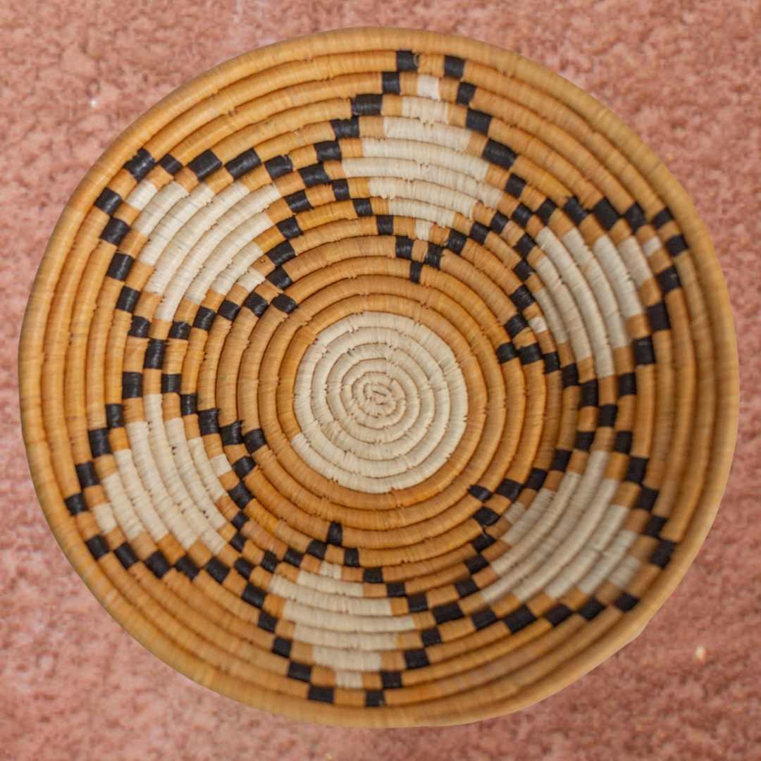 JustOne's yellow, tan, and black star design wall basket handwoven in Uganada