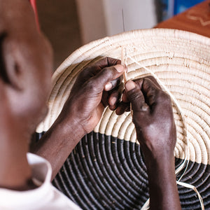 JustOne's half black, half tan wall basket, handwoven in Uganda