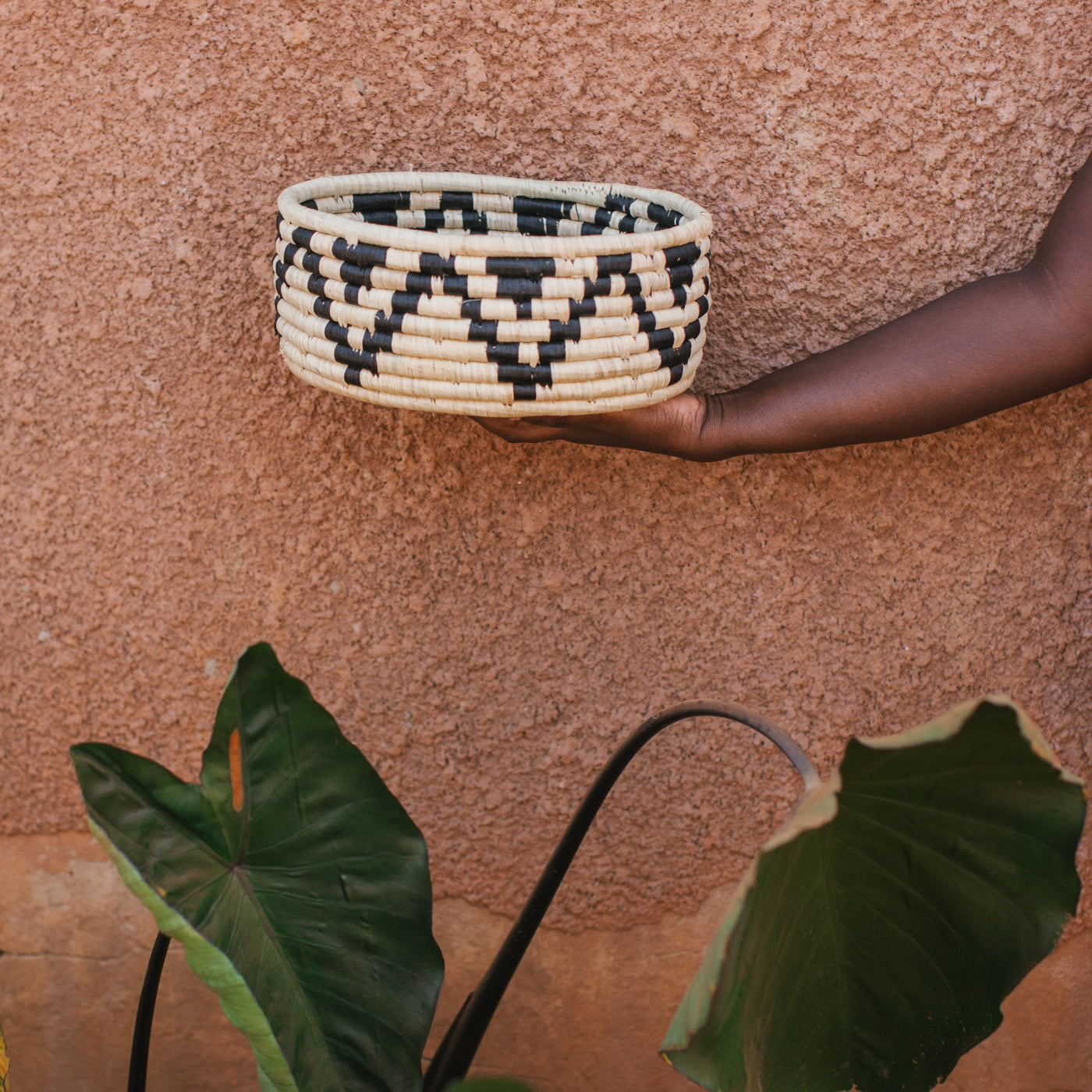 JustOne's deep basket with black and white designs handwoven in Uganda
