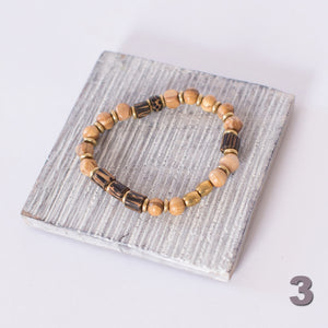 JustOne's stretch bracelet made with handcrafted wooden beads and brass rings, handcrafted in Kenya
