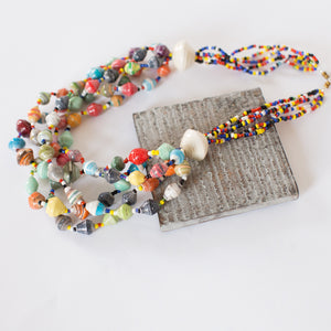 JustOne's chunky necklace with many multi-coloured paper beads, handcrafted by women in Uganda