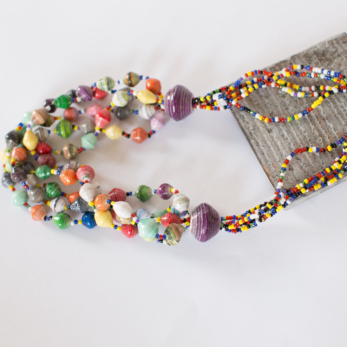 JustOne's chunky necklace with many multi-coloured paper beads, handcrafted by women in Uganda
