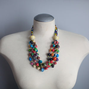JustOne's chunky necklace with many multi-coloured paper beads, handcrafted by women in Uganda