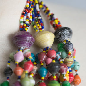 JustOne's chunky necklace with many multi-coloured paper beads, handcrafted by women in Uganda