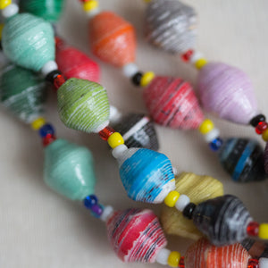JustOne's chunky necklace with many multi-coloured paper beads, handcrafted by women in Uganda