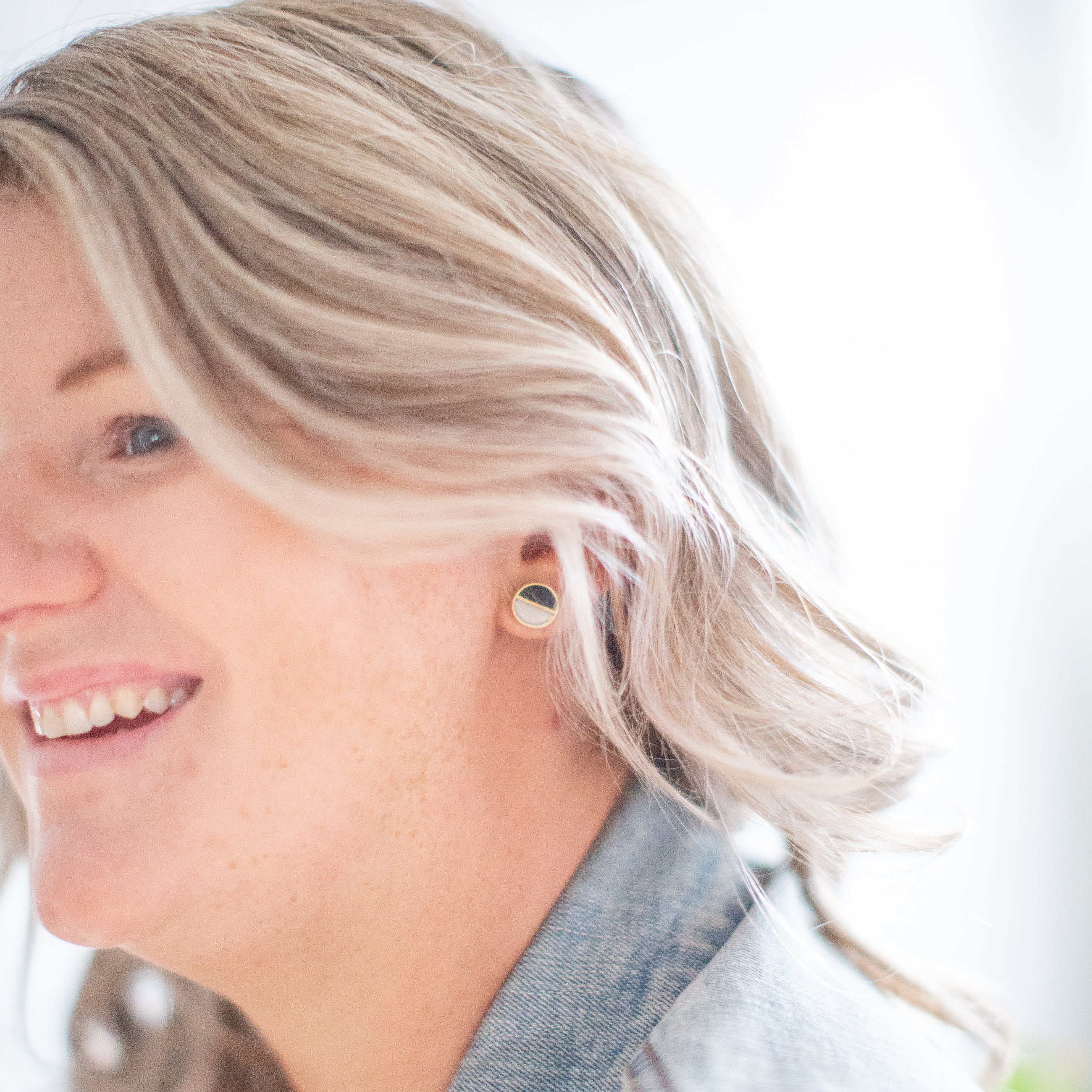JustOne's black and White circle studs with a brass outline ethically made from recycled materials in Kenya