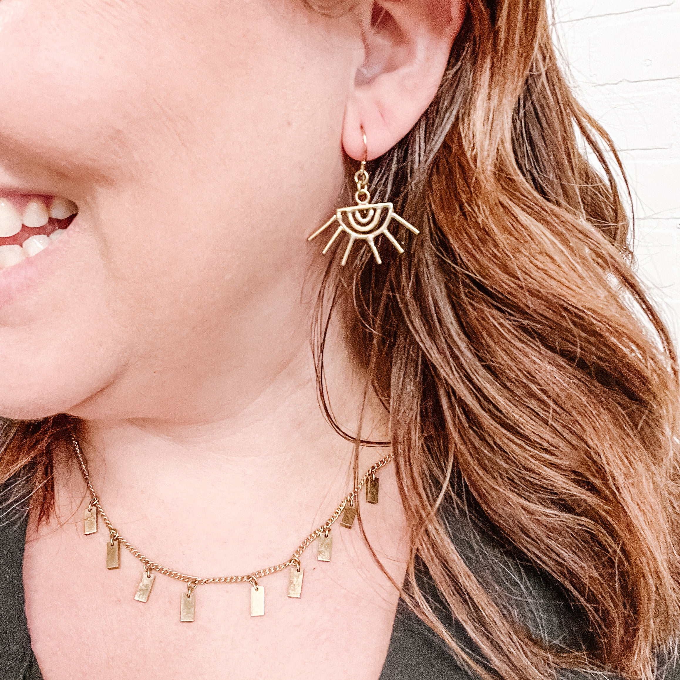 JustOne's brass eye shaped earrings with eyelashes sticking out of the earring, handcrafted in Kenya