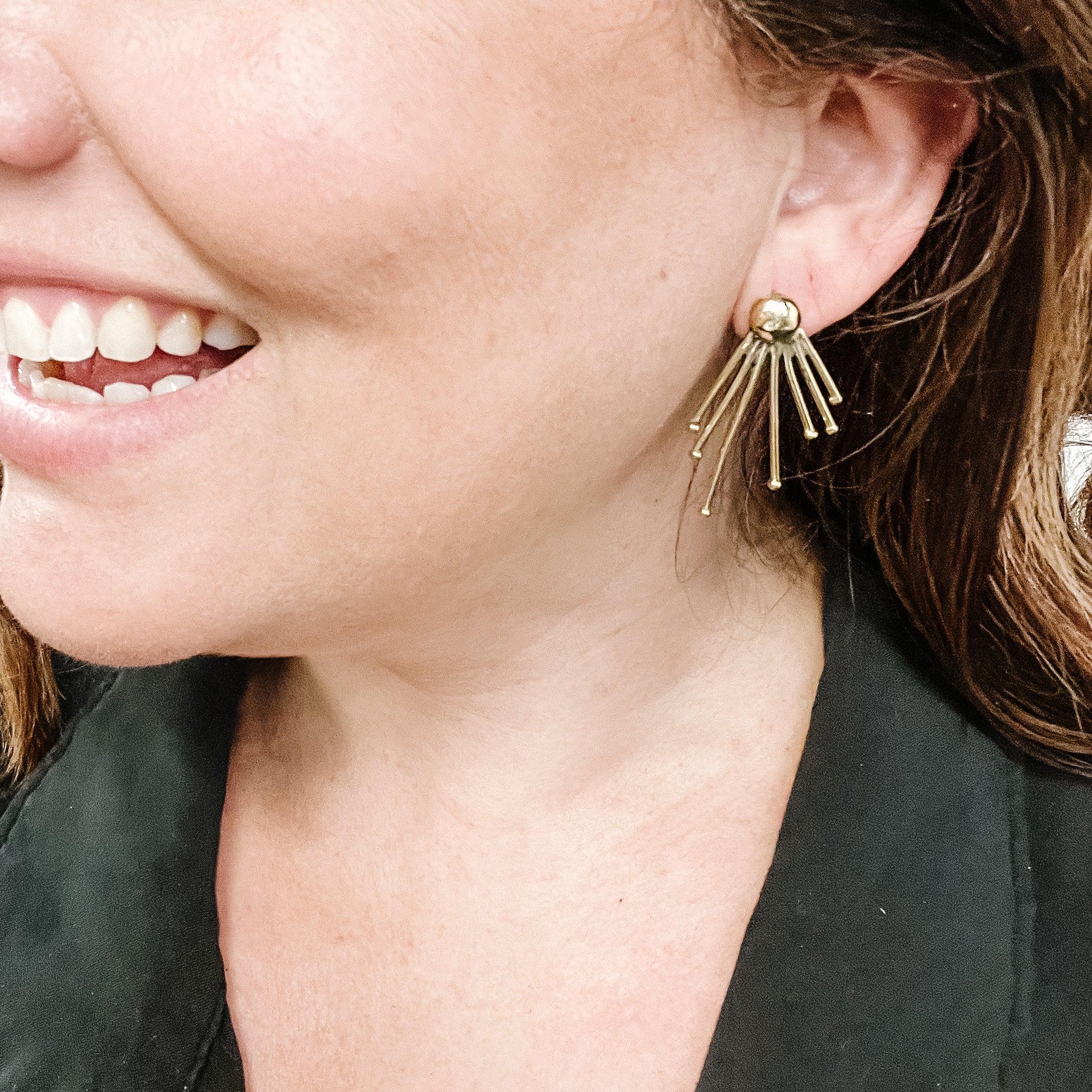 JustOne's brass earrings with lines coming out of the stud to resemble sunshine, handcrafted in Kenya