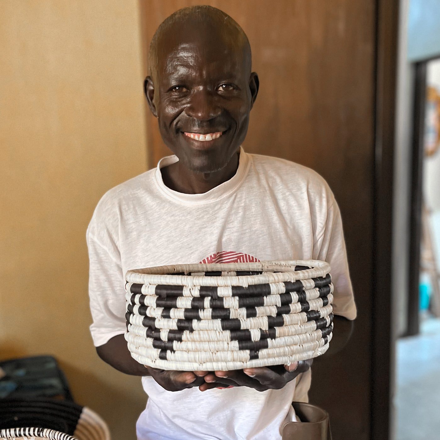 JustOne's deep basket with black and white designs handwoven in Uganda