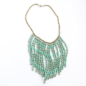 JustOne's necklace with several dangling strings of paper beads in teal, handcrafted in Uganda