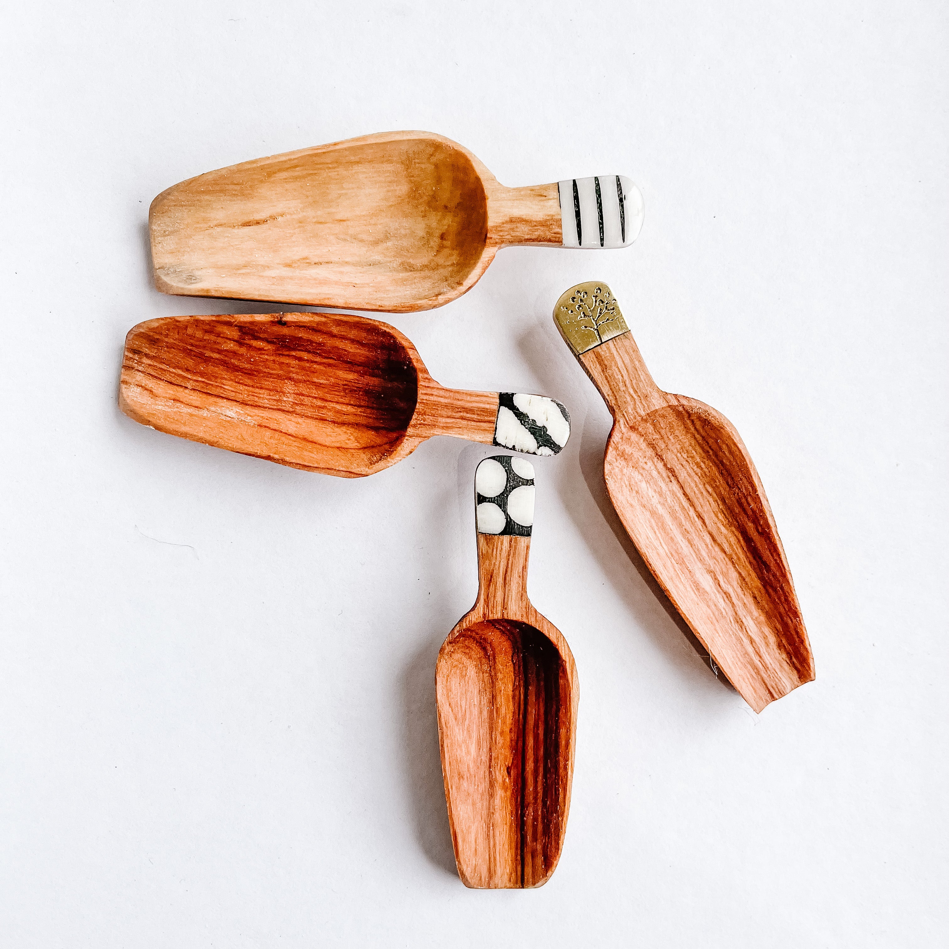 JustOne's four inch wooden scoops with various designed handles, handcrafted in Kenya