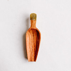 JustOne's four inch wooden scoop with a tree engraved recycled brass handle, handcrafted in Kenya