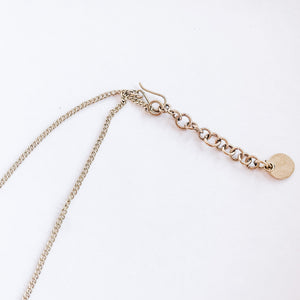 JustOne's brass necklace with small rectangle bars attached, handcrafted in Kenya