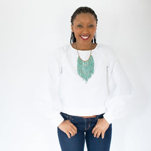 JustOne's necklace with several dangling strings of paper beads in teal, handcrafted in Uganda