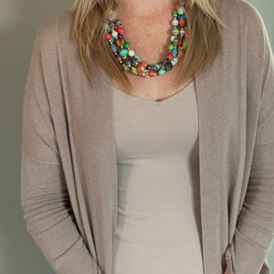 JustOne's chunky necklace with many multi-coloured paper beads, handcrafted by women in Uganda