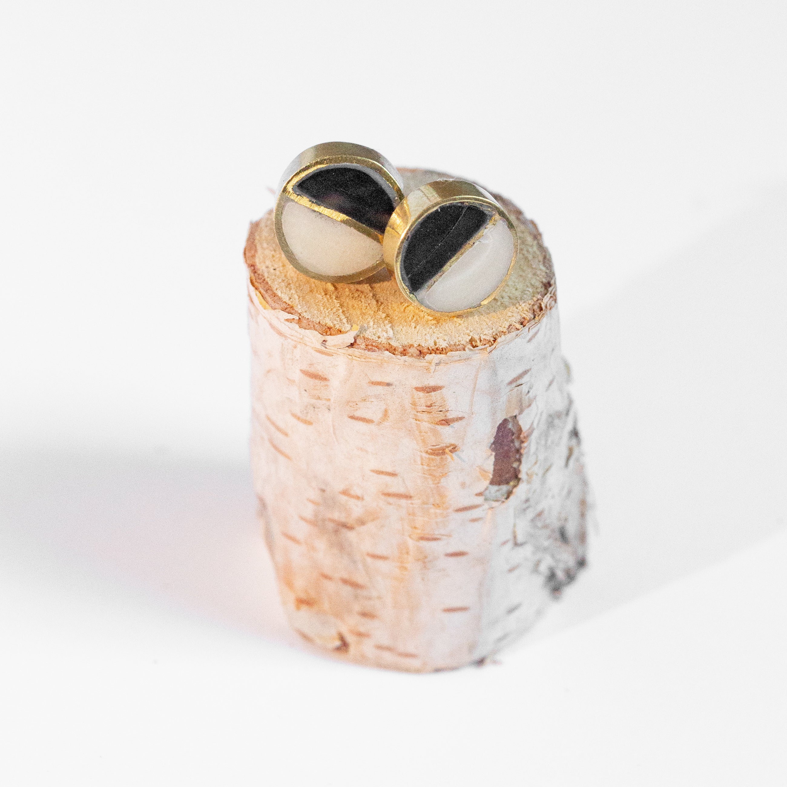 JustOne's black and White circle studs with a brass outline ethically made from recycled materials in Kenya