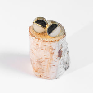 JustOne's black and White circle studs with a brass outline ethically made from recycled materials in Kenya