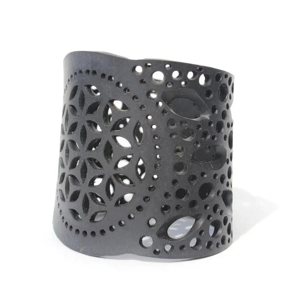 JustOne's black rubber bracelet with intricate detailed holes to make a flower like design handmade from recycled materials