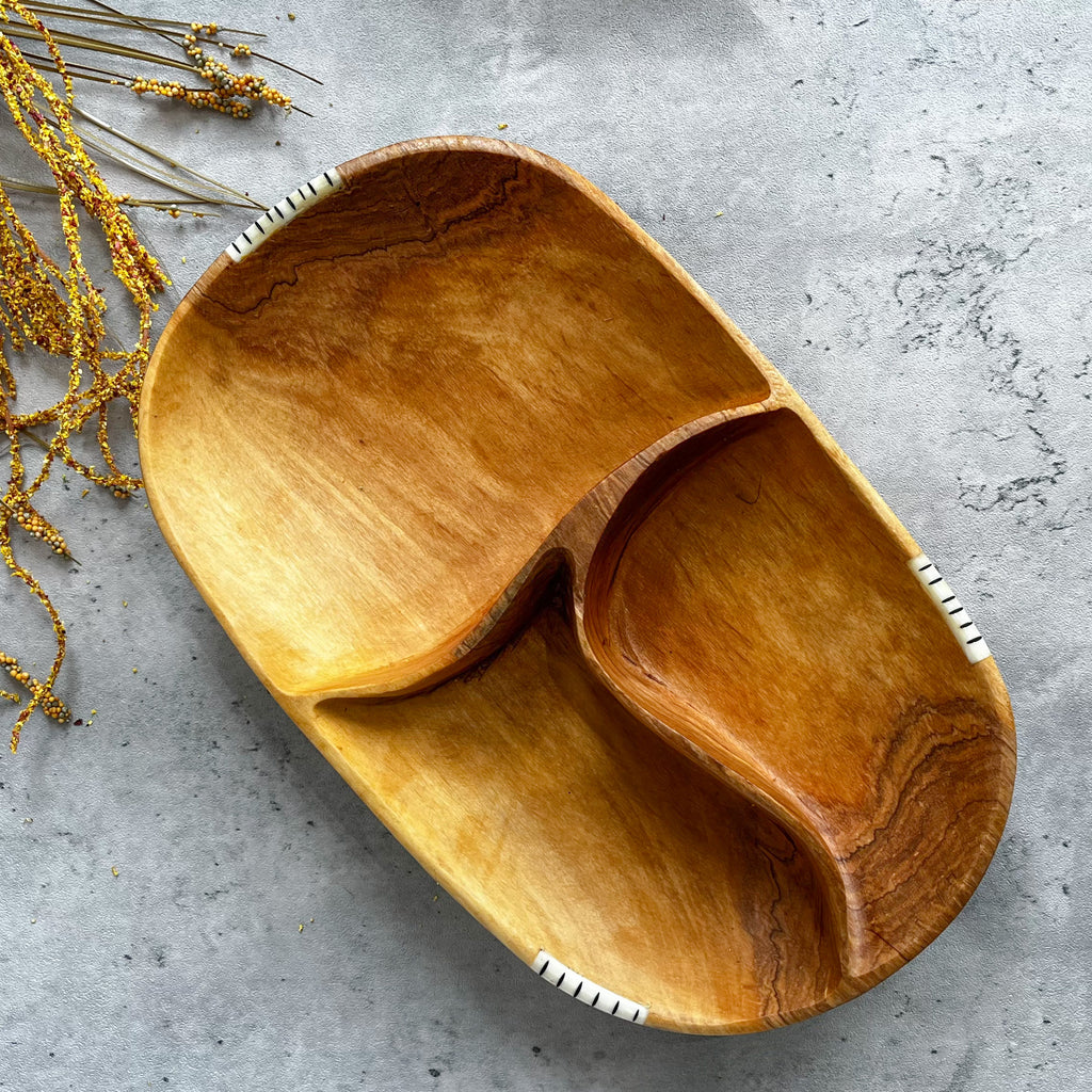 JustOne's oval wooden bowl with pieces of wood in the middle to create three sections, handmade in Kenya