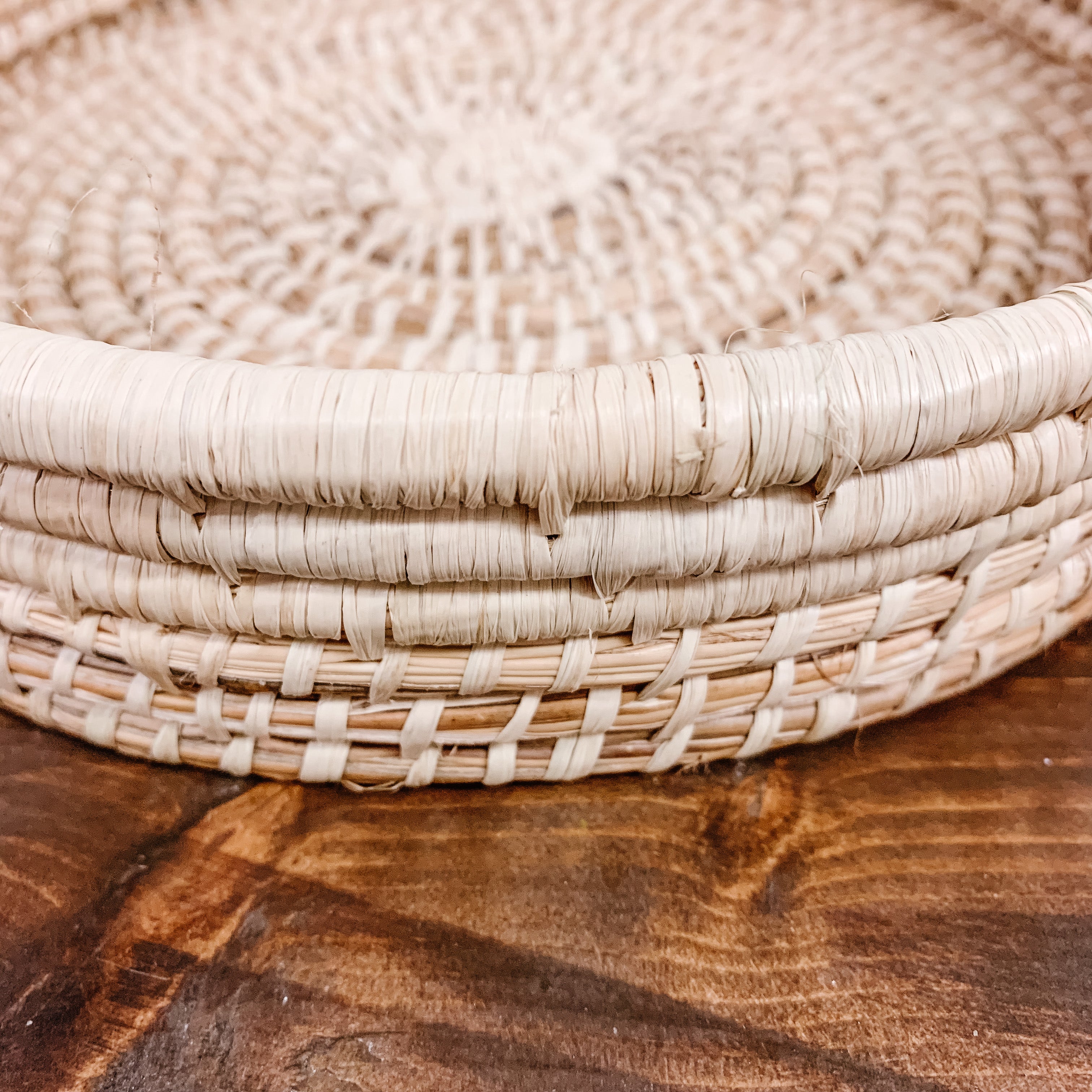 JustOne's tan medium, shallow basket, handwoven in Uganda