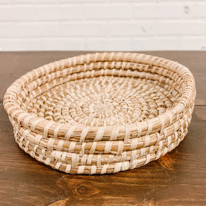 JustOne's tan medium, shallow basket, handwoven in Uganda